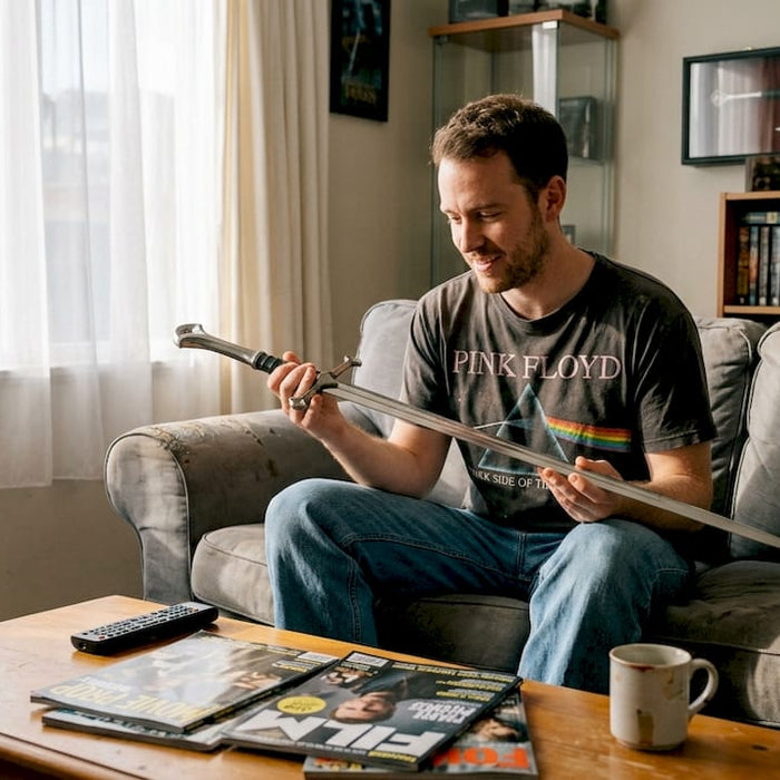 Collector examines sword in lived-in living room