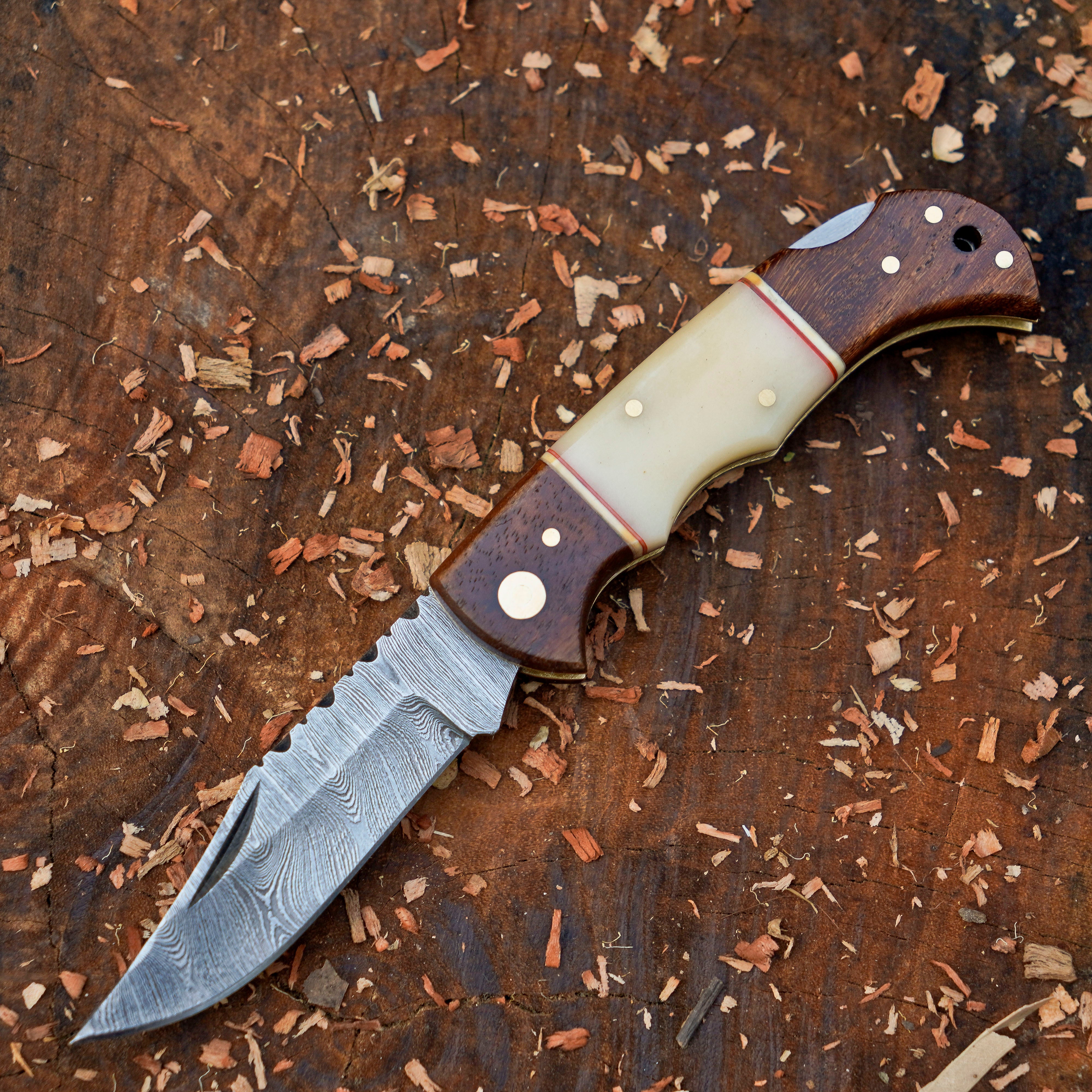 Horned Hunter Damascus folding knife with wood and bone handle