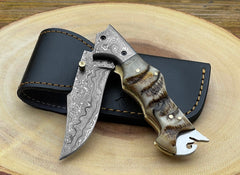 Handmade Damascus folding pocket knife with ram horn handle and leather sheath