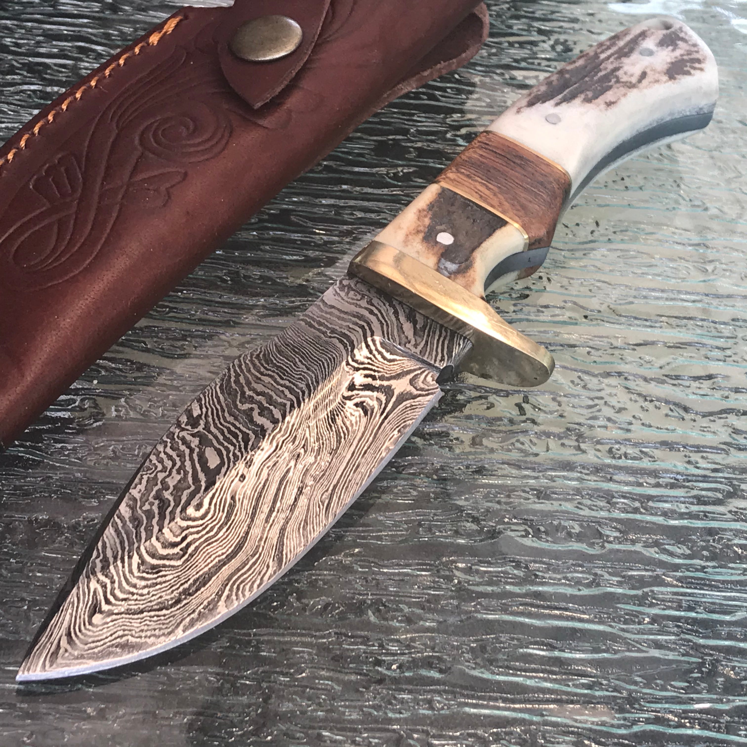 9-inch Damascus skinning knife with brown stag handle and sheath