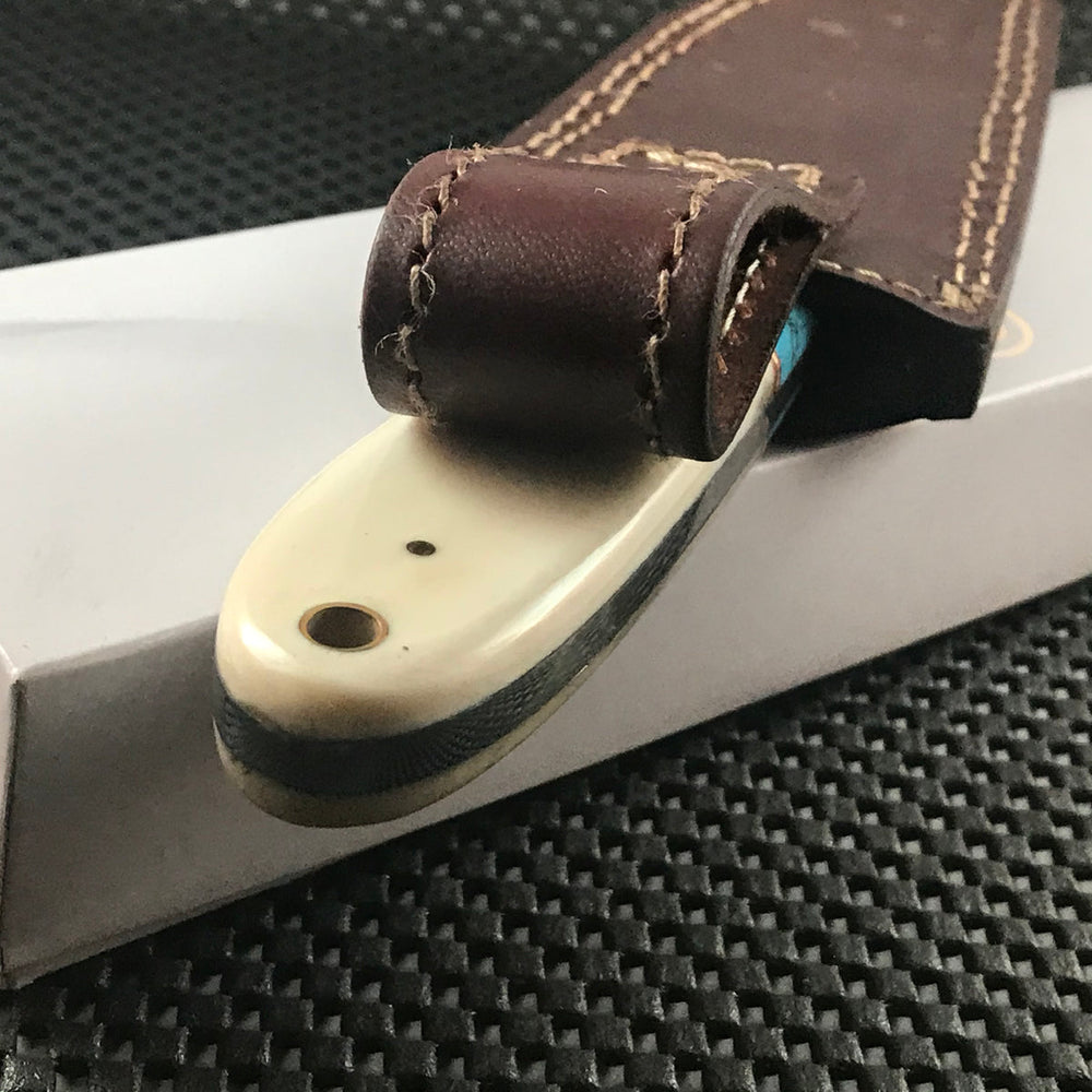 Handmade blue Damascus steel skinning knife with horn handle and leather sheath