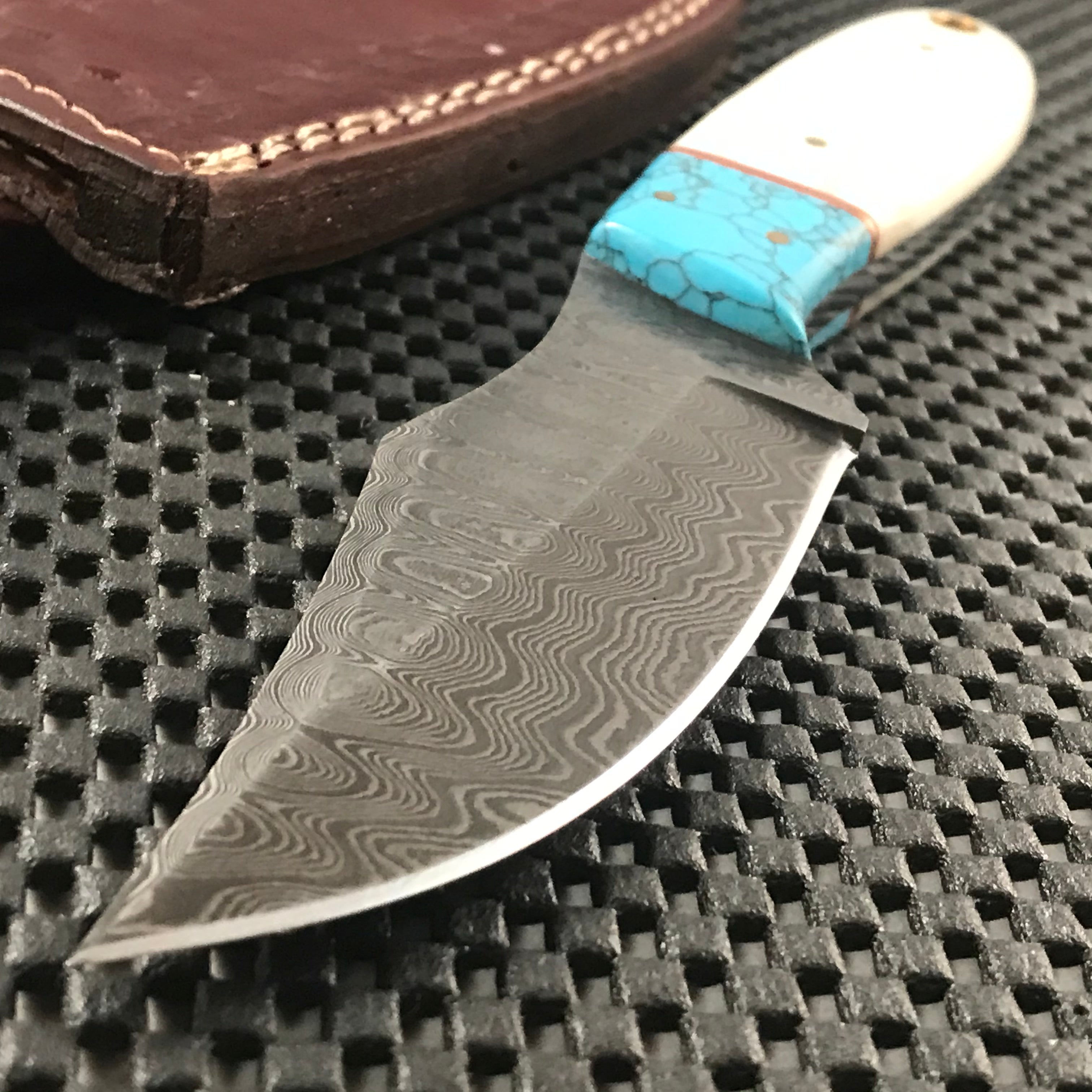 Handmade blue Damascus steel skinning knife with horn handle and leather sheath